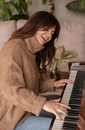 attractive-young-woman-playing-the-piano-at-home2.jpg