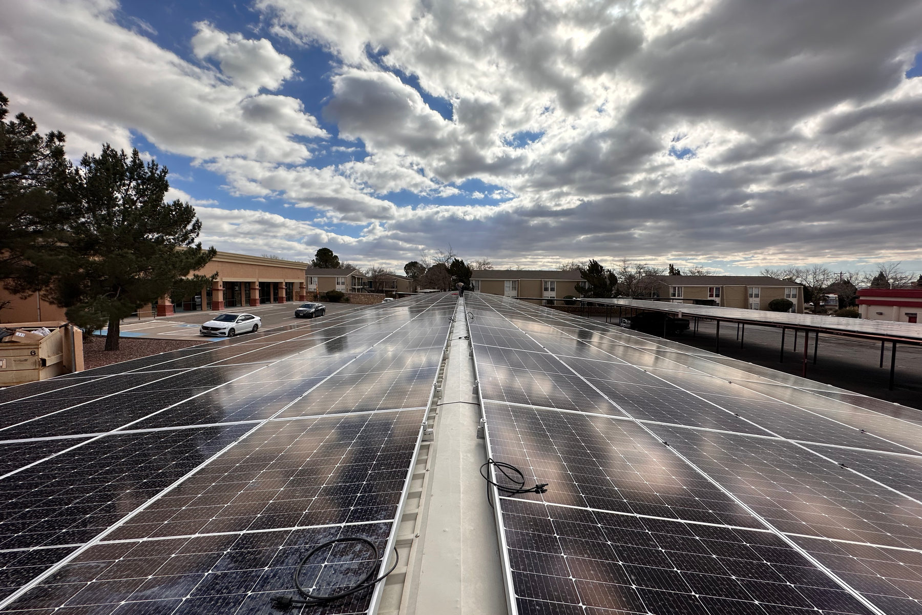 A 257.3 kW DC solar carport system serving a multi-tenant office building on El Paso's east side, covering roughly 40% of the building's annual electricity consumption.