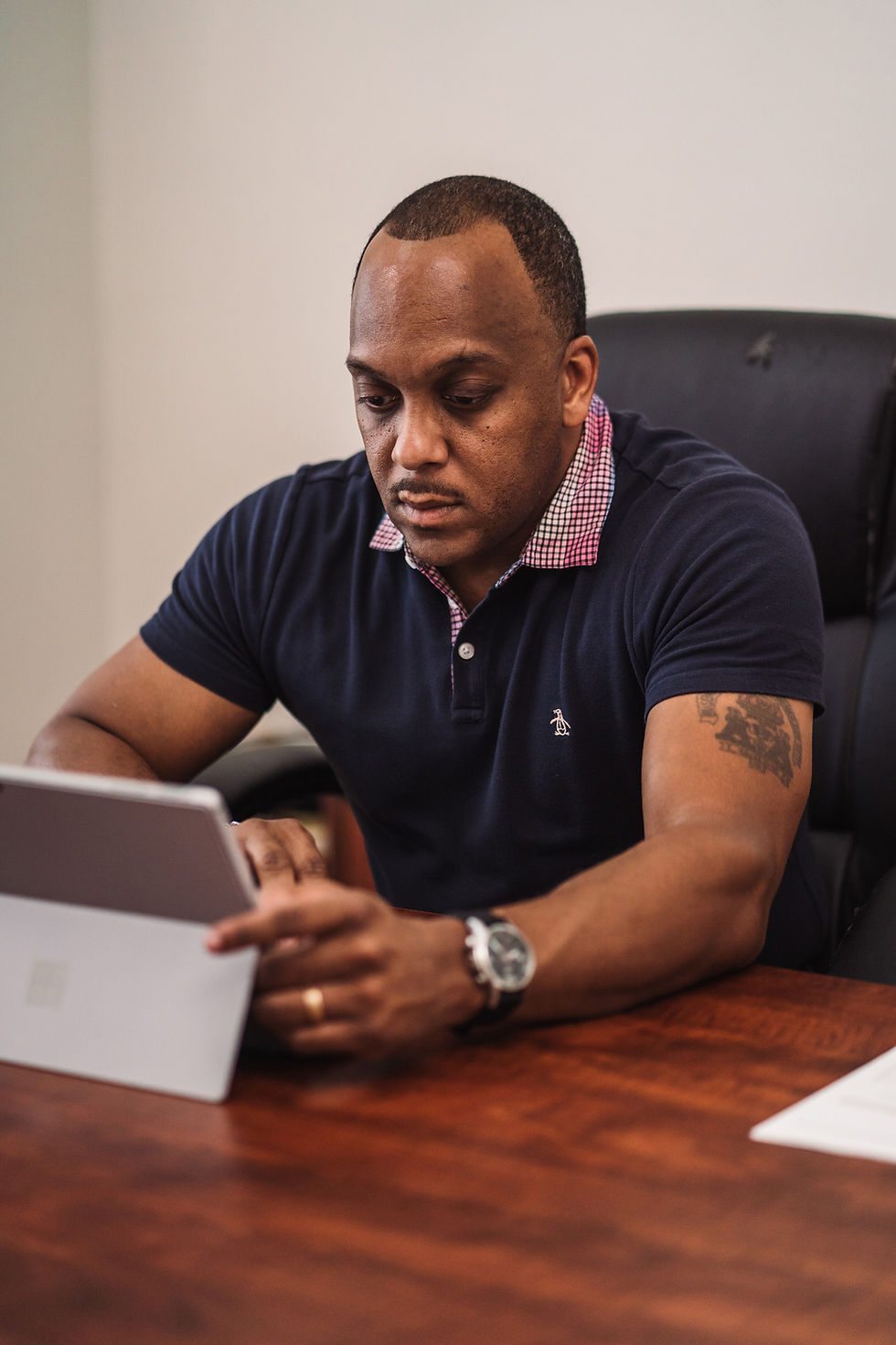 Man tapping screen of tablet set up on table Univerus Waste & Recycling
