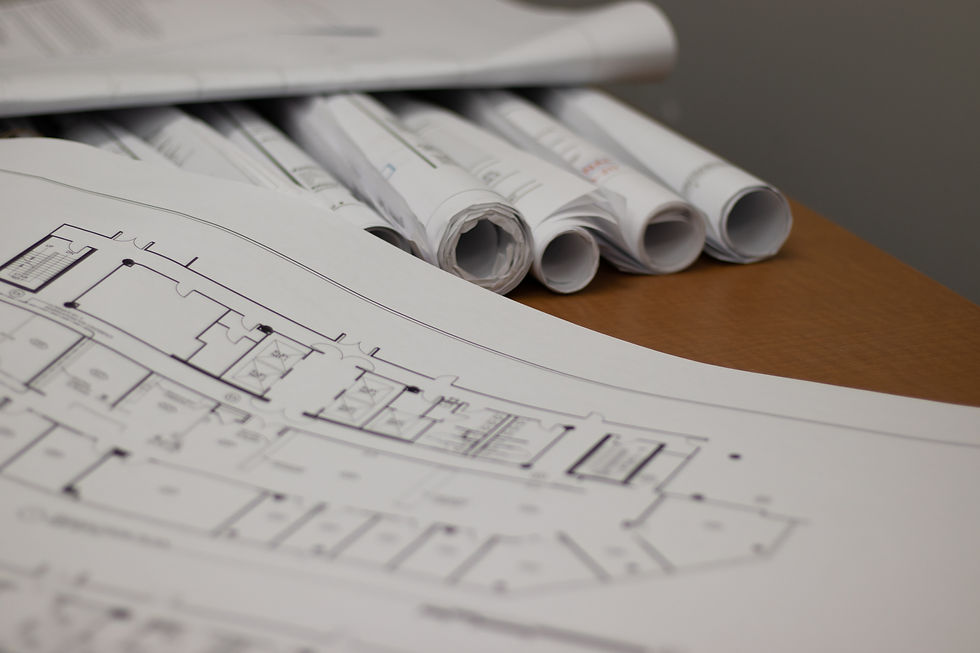 Building layout plans spread out on table