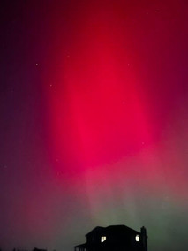 northern lights over a house