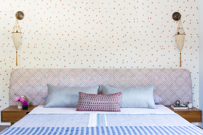 Upholstered headboard primary bedroom with wallpaper