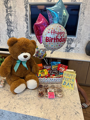 Romantic gift basket with flowers, chocolates, and themed items for hotel guests in Orlando