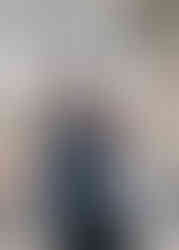 Couple looking at each other and embracing under canopy of trees in Raglan during a photoshoot