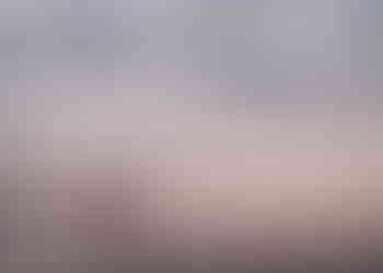 couple holding hands walking along Raglan beach at sunset after their wedding during their wedding photography