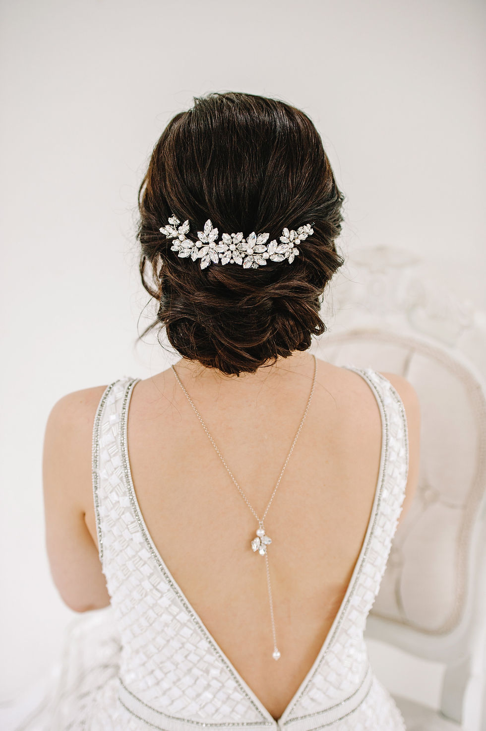 Silver wire bridal headpiece embellished with diamanté and ivory pearls, modelled by bride