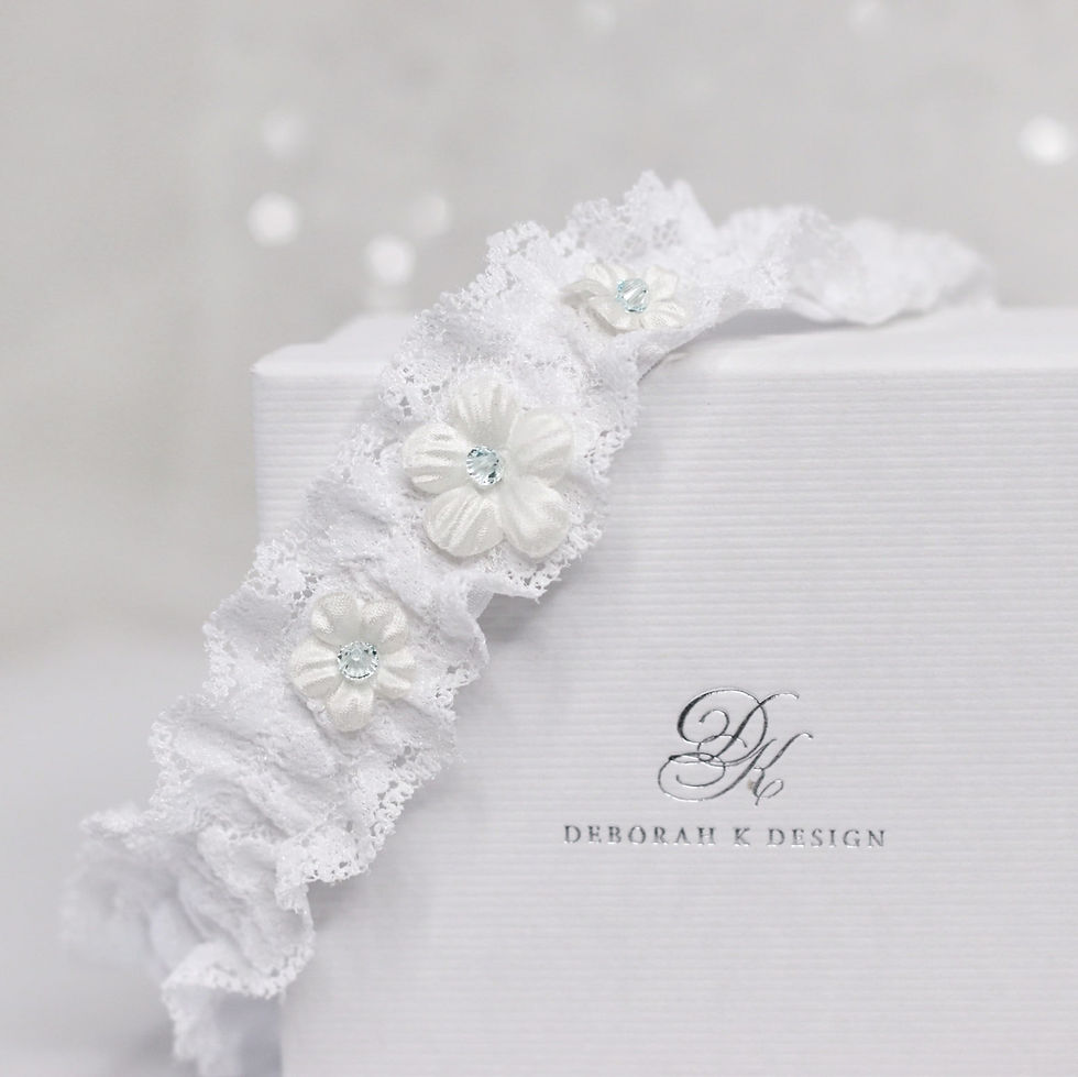 Thumbnail: Lace bridal garter embellished with fabric flowers and blue crystal centres.