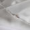 Thumbnail: Silver bracelet with two cubic zirconia solitaires either side on an ivory pearl