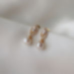 Gold earrings of cubic zirconia with silver edges and a short pearl dropper