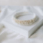 Ivory satin covered bridal headband embellished with various sizes of ivory pearls and a diamante chain.