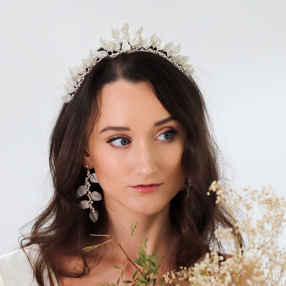 Thumbnail: Silver wire bridal headpiece embellished with ivory clay leaves and ivory pearls modelled by bride