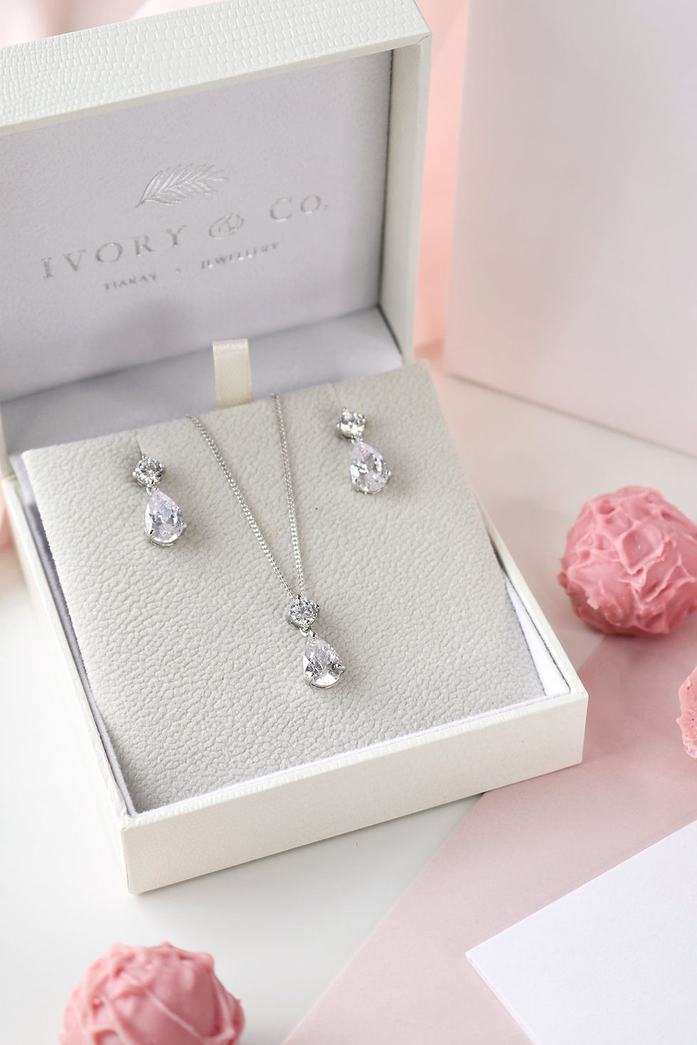 Thumbnail: Silver pear shape cubic zirconia dropper earrings with matching necklace displayed in gift box
