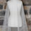 Thumbnail: Ivory tulle veil with satin edging