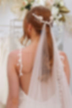 Ivory tulle long ponytail veil modelled by bride