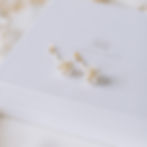 Gold dropper earrings with ivory clay drop