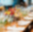 Event table set with plateware, glassware and colorful flowers