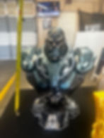 “Hand-painted metallic-turquoise 3D-printed bust on techno base, front-left angle with measuring tape showing ~10–11 inch hei