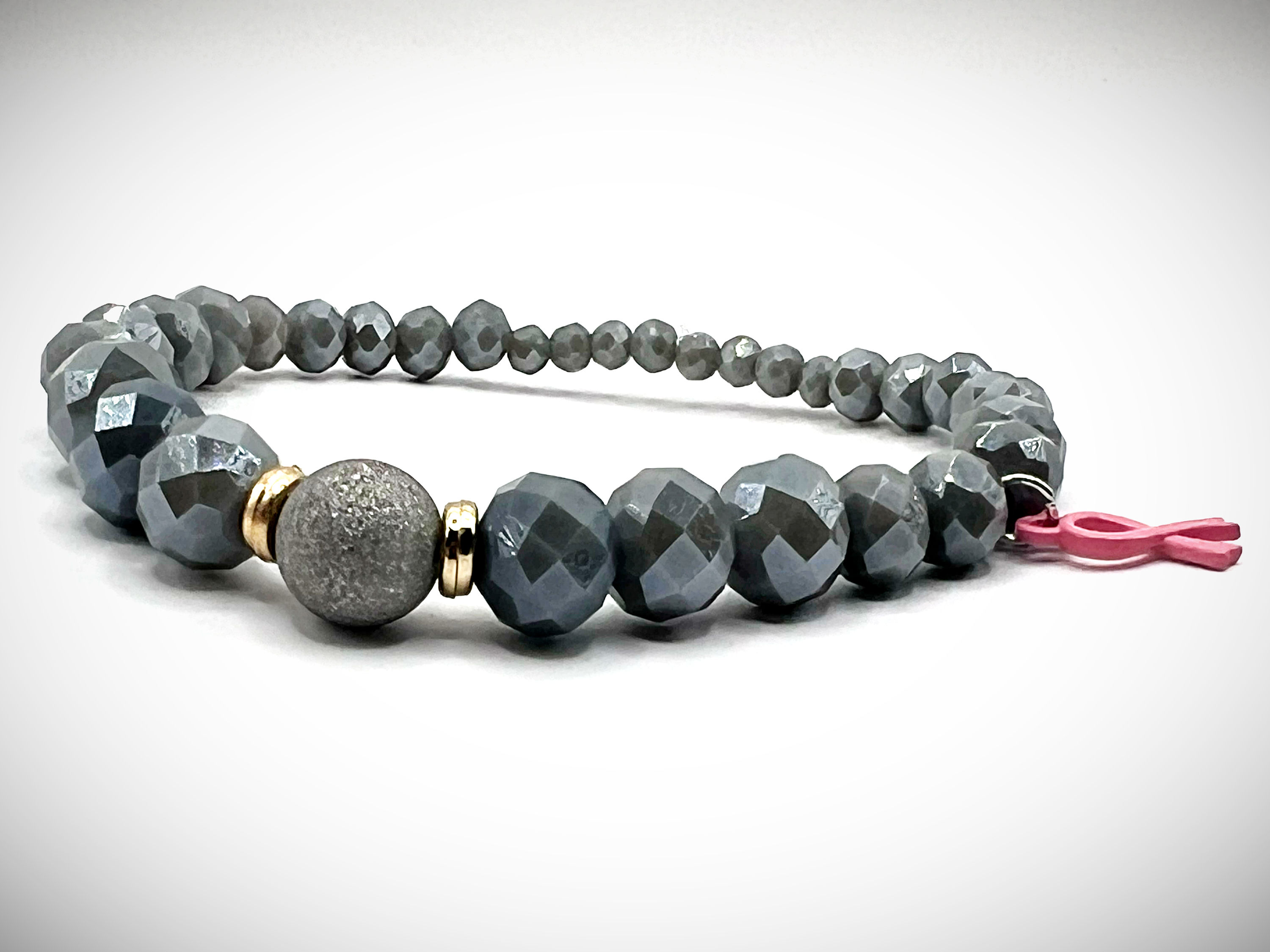 Strength in Silver Breast Cancer Awareness Bracelet with faceted silver beads and pink ribbon charm.