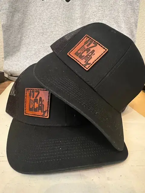 Thumbnail: Stylish black mesh-back trucker hat featuring a brown leather patch with "417 Local" and Route 66 emblem. Ideal for Missouri