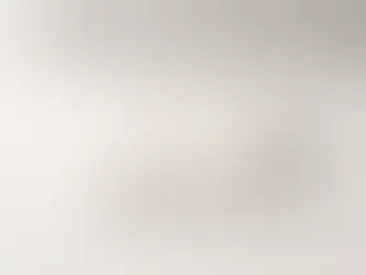 Single folded blank cotton T-shirt displayed on a clean desk in a minimalist home workspace