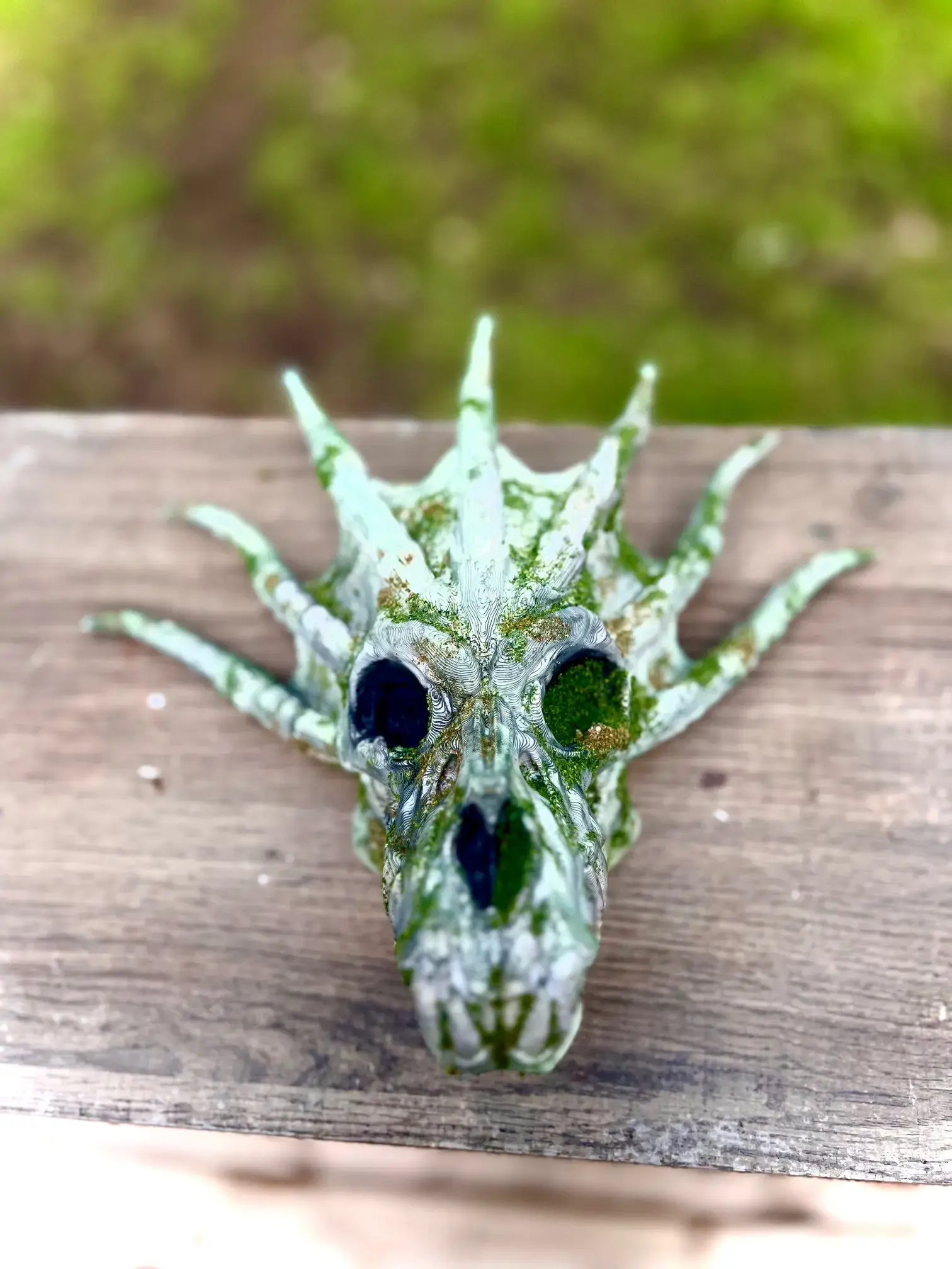 Moss-covered 3D printed Water Dragon Skull from front view – hand-painted fantasy decor