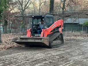 Skid steer completing dirt work and grading near Neosho Missouri
