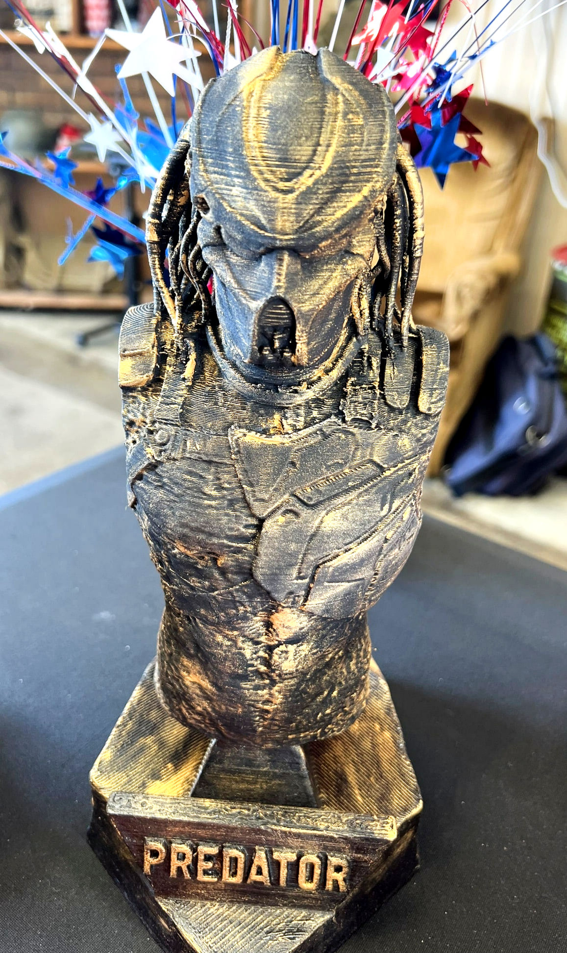 Close-up of 6" hand-painted Predator bust featuring detailed armor and a dark metallic finish.