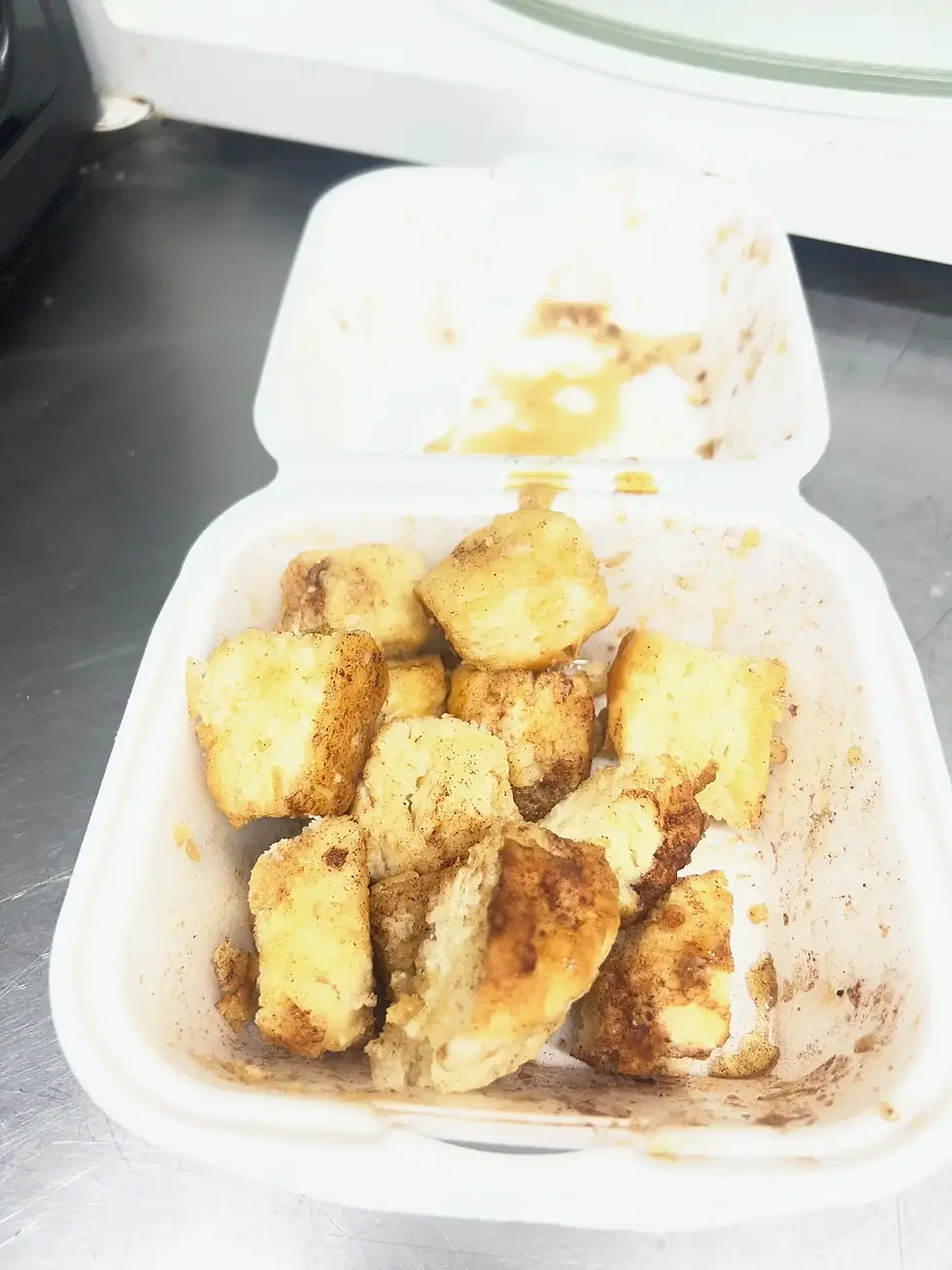 Image of diced up biscuits covered in maple syrup and cinnamon dust.