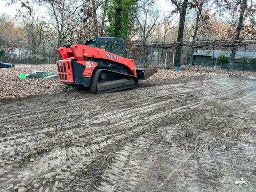 Skid steer completing property grading work near Neosho Missouri