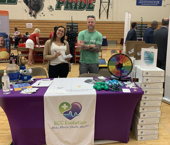 two people behind vendor booth at a new teacher orientation event