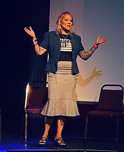 Woman with hands up on stage