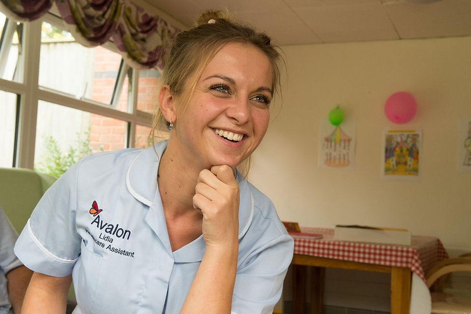 Avalon care home staff member smiling towards the camera