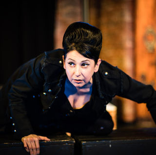Erica in dressed in black climbing on a box.