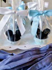 Mickey Mouse ear favors in clear bags with white and blue bows
