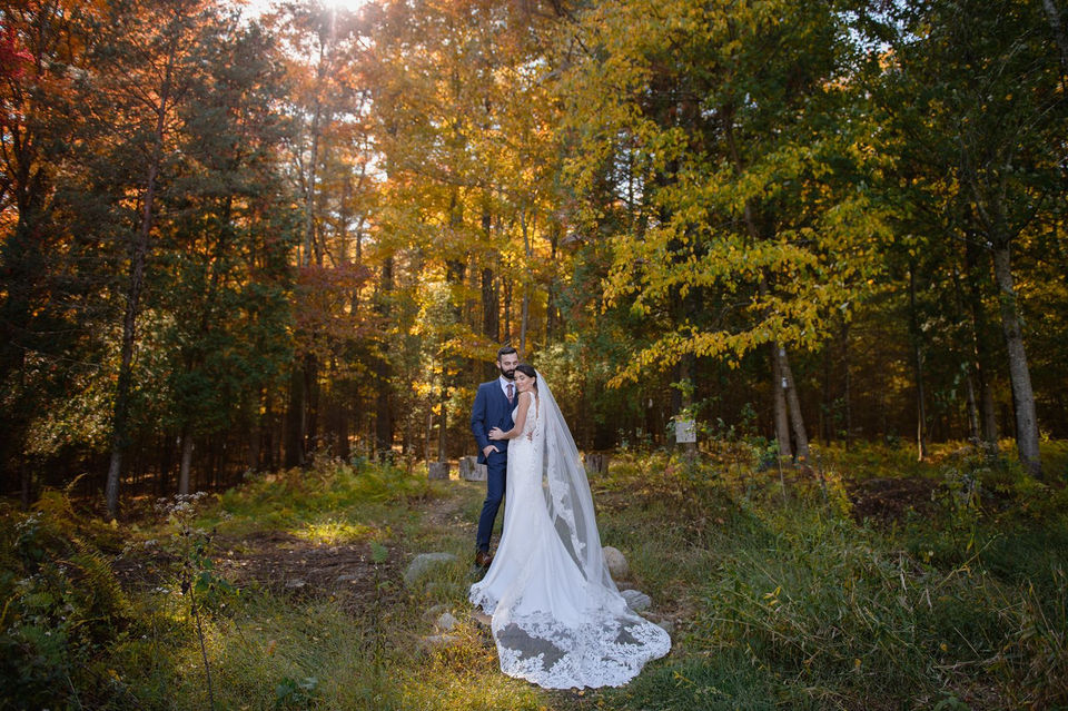 Bride and groom in front of autumn leaves at Sylvan Ridge Farm, a barn wedding venue where NJ, NY, and PA meet