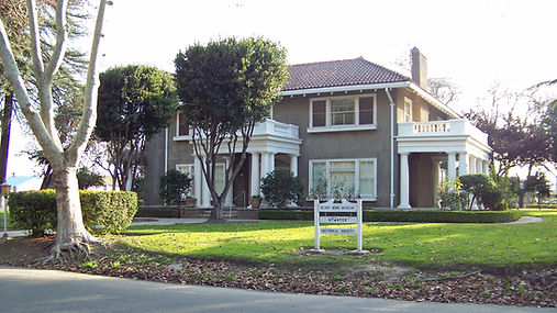 Bloss House Museum in Atwater with white columns, trees and landscaped grounds
