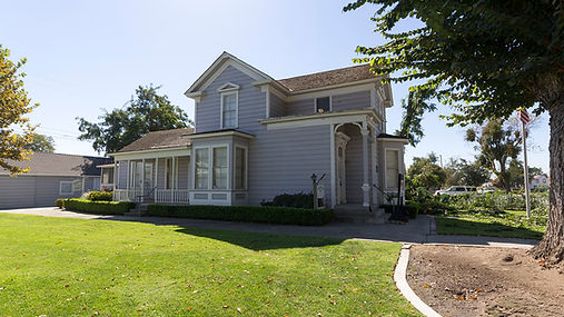 Daniel Whitmore House in Ceres with its front porch, lawn and shade tree