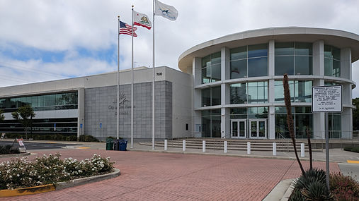 San Ramon City Hall with its curved glass entrance, flags and brick plaza