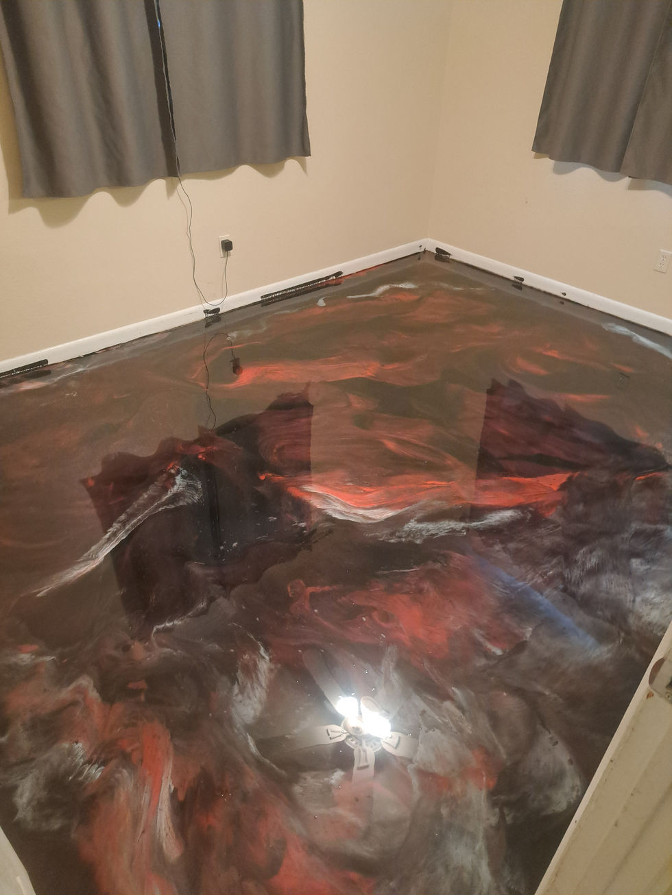 Custom red and black metallic bedroom floor adding a vibrant touch