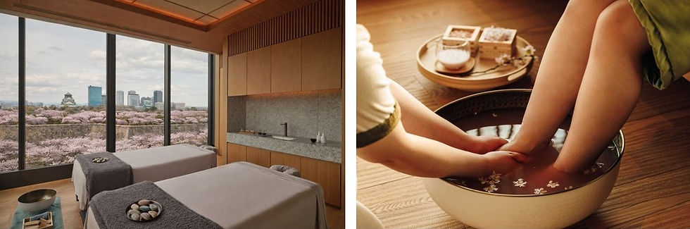 Spa room with two massage tables overlooking a cherry blossom garden. Close-up of a foot bath on a wooden floor, creating a serene mood.