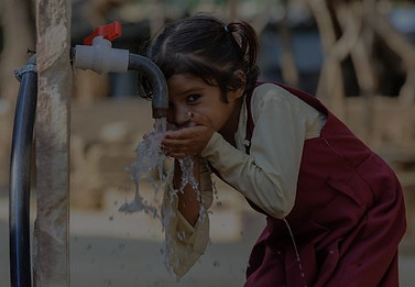 Village girl drinking fresh water