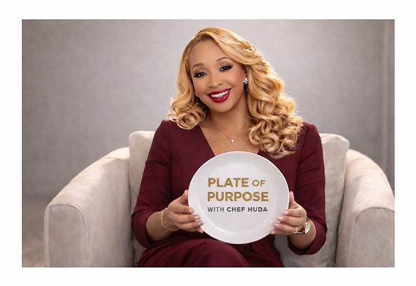 Chef Huda holding a decorative Plate of Purpose Plate.