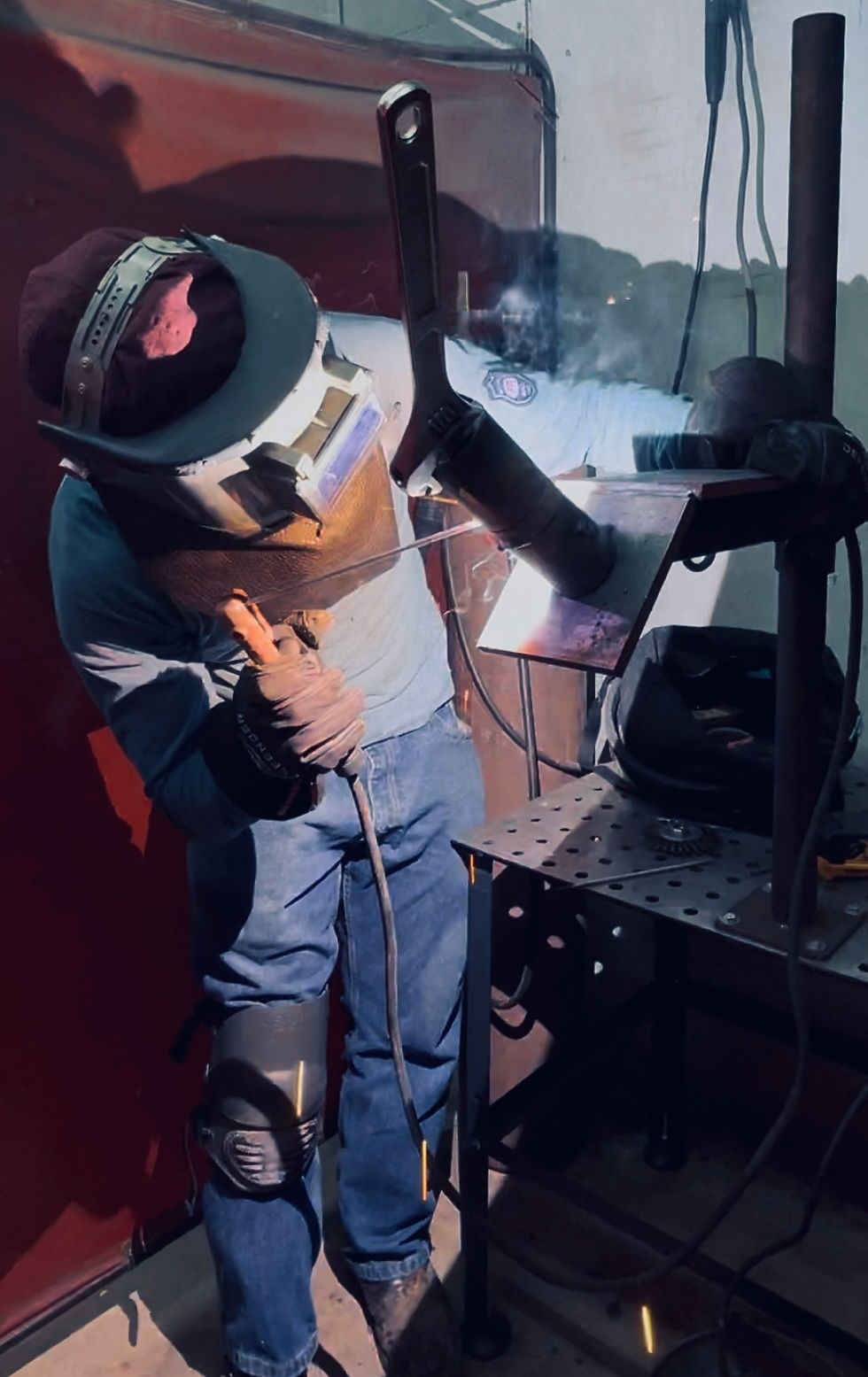 A welding student welding a 6g test pipe