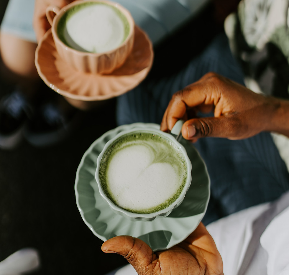 Two women holding cups of coffee and matcha