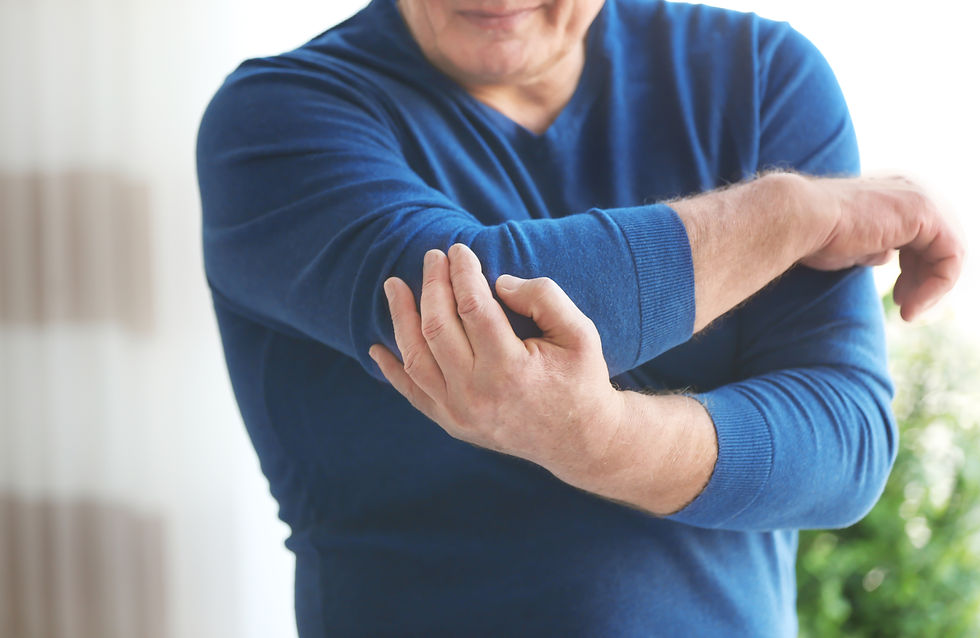 mature-man-suffering-from-elbow-pain-at-home-2026-03-27-00-51-28-utc.jpg
