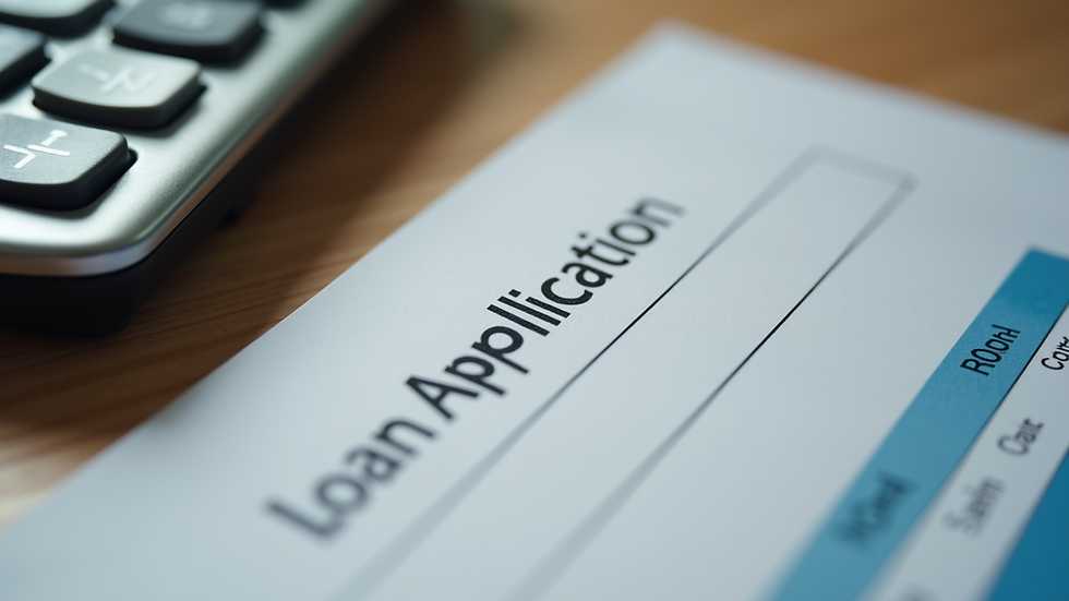 Close-up view of a calculator and loan application form on a table