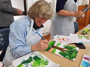 Lady painting tree using acrylics