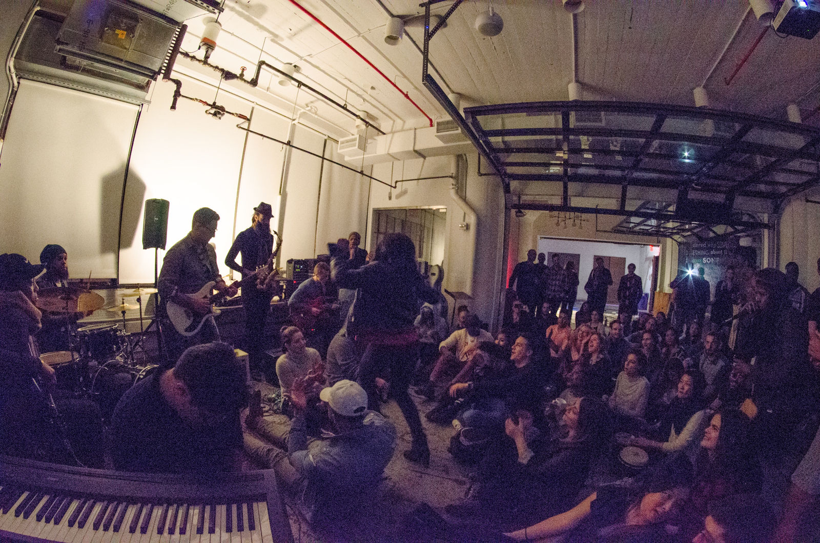 A YES JAM: musicians playing to a crowd sitting on the floor