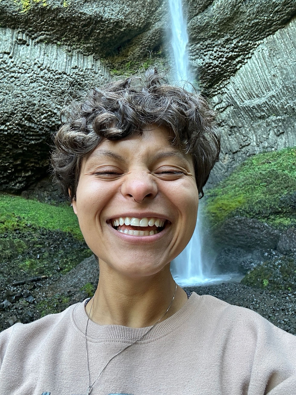 Vanessa Agosto, founder of Life Soul Wellness, smiling in front of a waterfall.