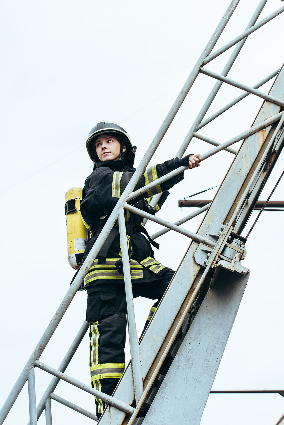 Firefighter in protective gear climbing a ladder.